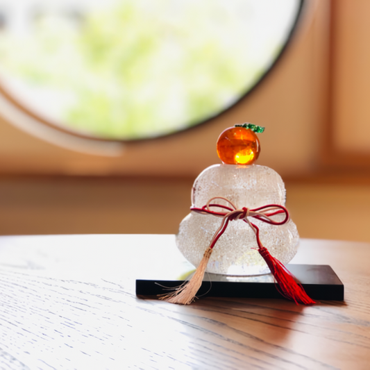 Large glass Kagami mochi with transparent bubbles and granular mandarin oranges