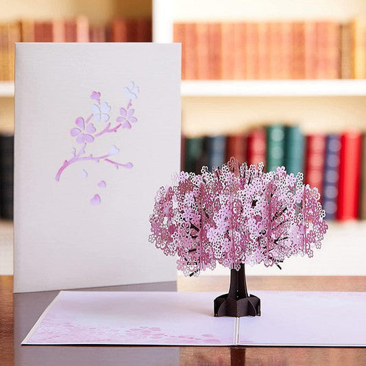 A message card with a beautiful cherry blossom tree that looks like a paper cutout